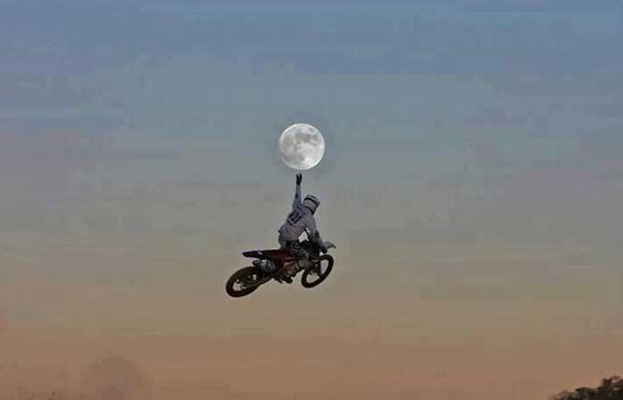 Motorcyclist catching the moon