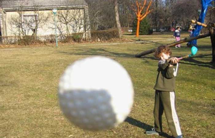 Golf ball flying into camera