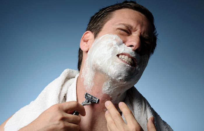 A man shaving in pain