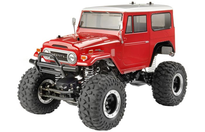Tamiya RC Toyota Land Cruiser, red, tilted, on a white background.