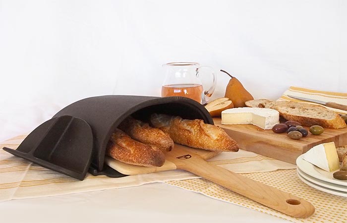 The Fourneau Bread Oven Placed On A Table With Food