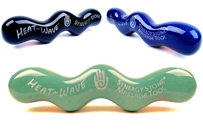 Three Heat-Wave Synergy Microwaveable Stone Massagers, black, blue, and lime, on a white background.