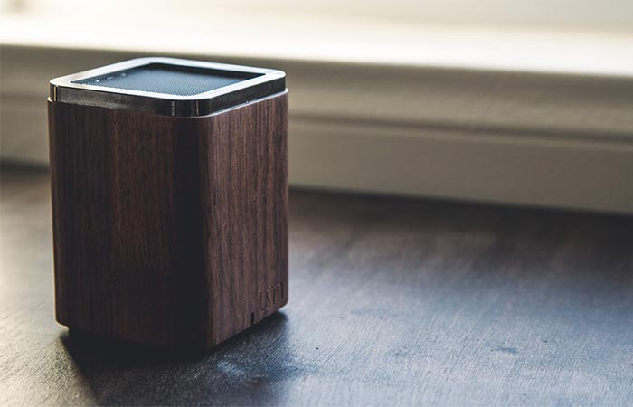 Brown LSTN Satellite Bluetooth Speaker On A Wooden Surface