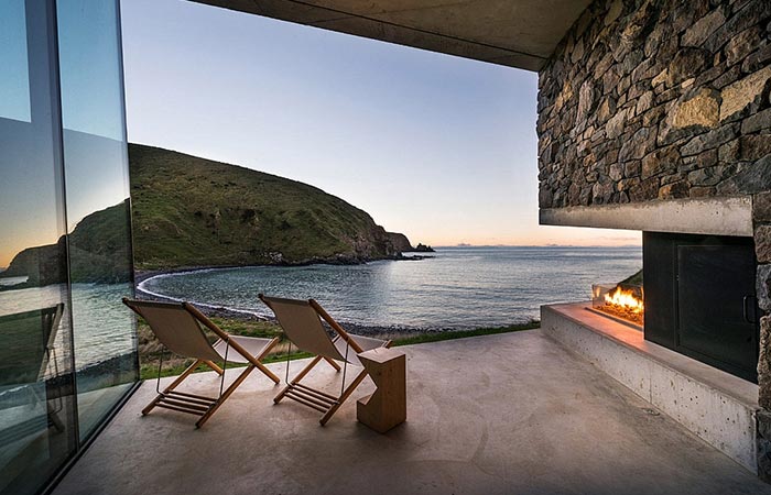 Seascape Retreat on a South Pacific Cove, the terrace with two chairs at sundown.