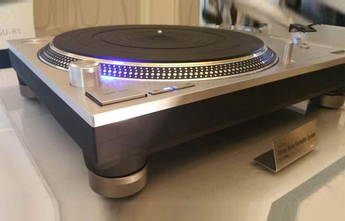 Technics SL-1200GAE on a table, tilted view.