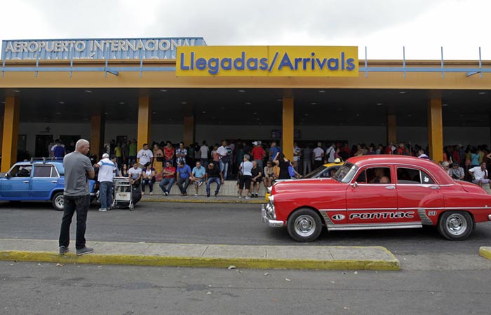 The street and people in front of the airport in Cuba.