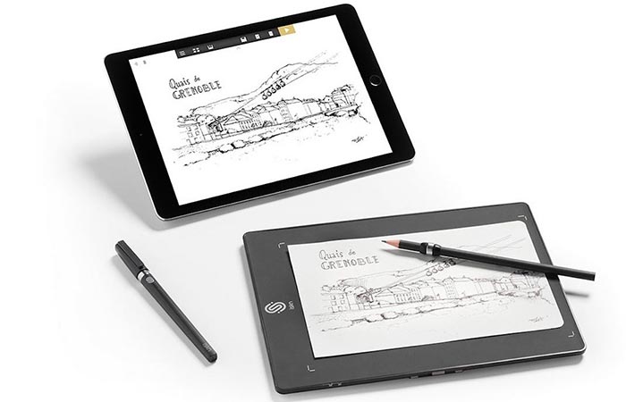 A tablet and The Slate - Smart Drawing Pad with two pens, on a white background.