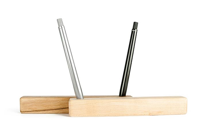 Two SENS Pens On A Wooden Stand
