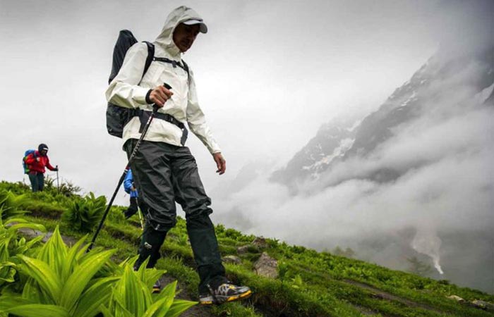A Guy Hiking In Columbia Outdry Extreme Eco Rain Jacket