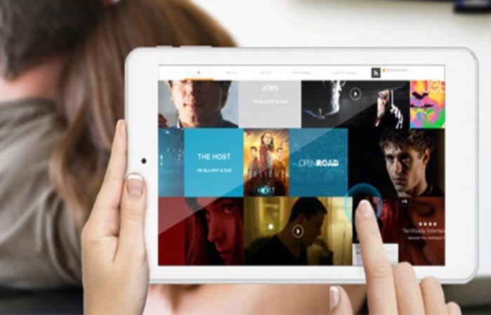 A woman selecting movies while streaming to the TV on the iWork8