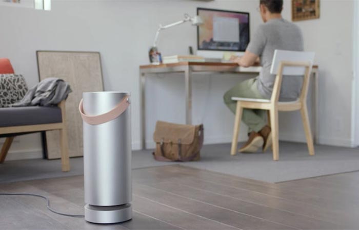 Molekule Air Purifier In A Room With A Guy Sitting At The Desk