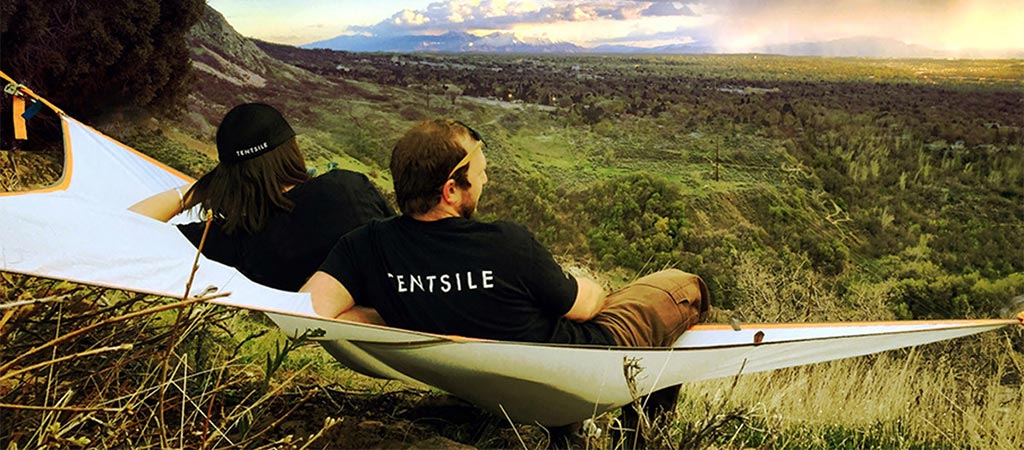 Two people looking over the landscape while relaxing in a Tentsile T-Mini Hammock