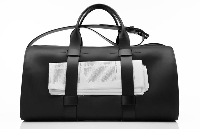 Black Troubadour Day Bag With Papers In It