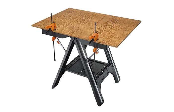 WORX Pegasus Folding Work Table in table mode with a piece of hard board on it