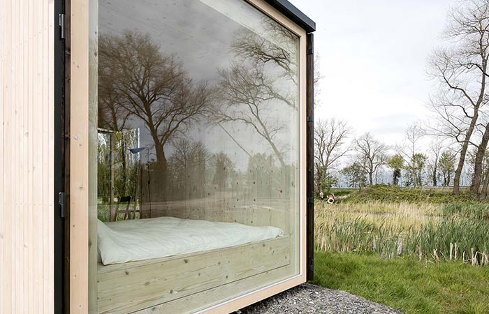 A glass window on a wooden cabin