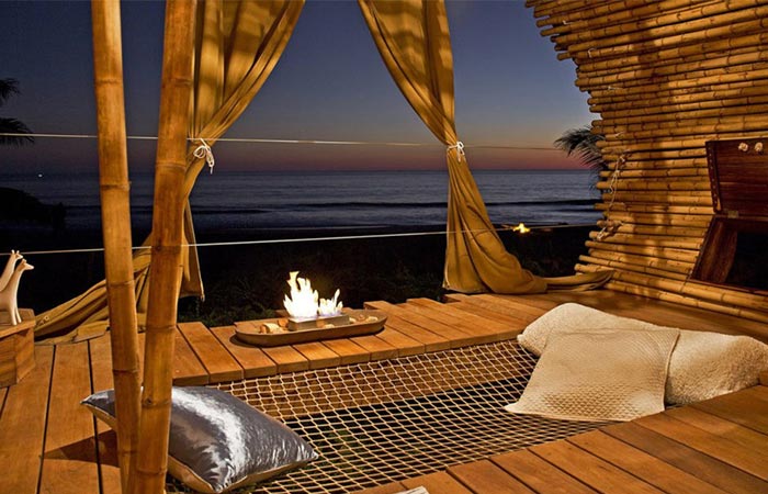 the interior of the Playa Viva treehouse room and the view of the ocean