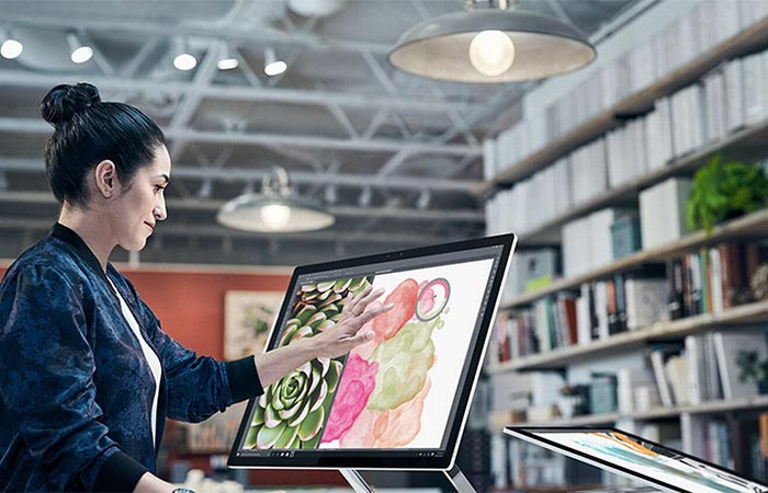 Woman using the Microsoft Surface Studio