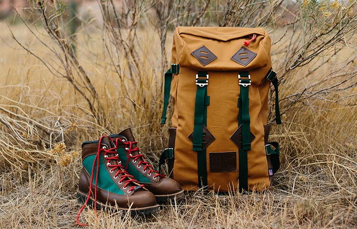 leather boots next to a backpack