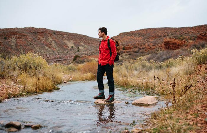 a guy standing on a stream