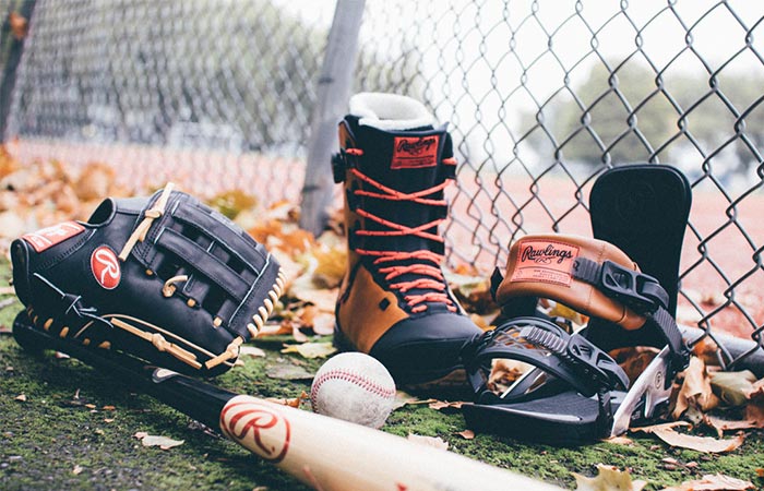Fuse By Ride boot next to harness, baseball, baseball bat and mitt.