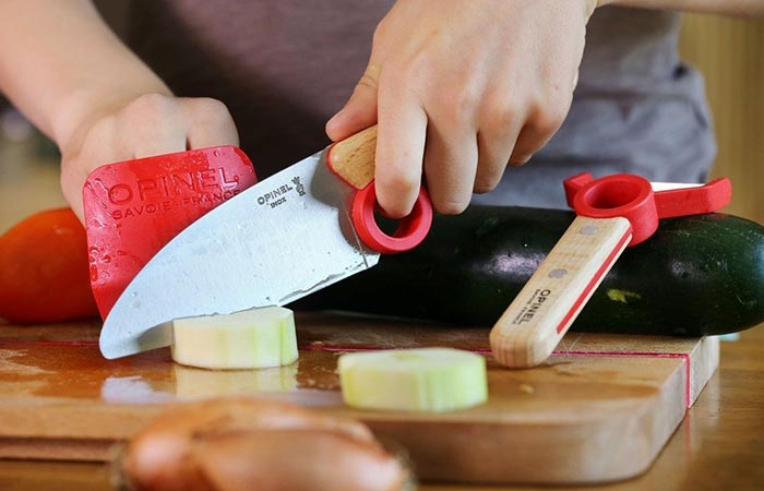 using a knife to cut onion