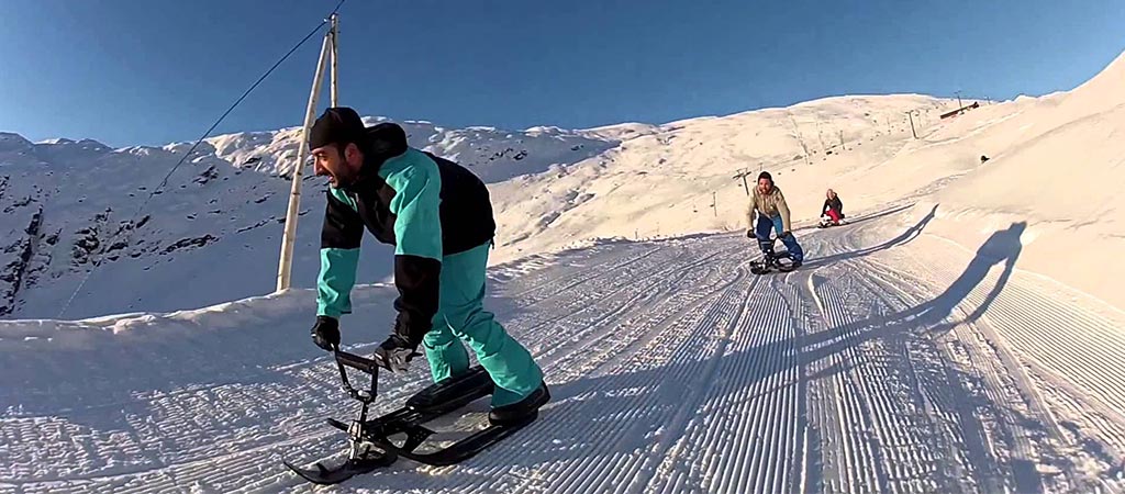 Men using the Stiga USA Snowracer on a slope
