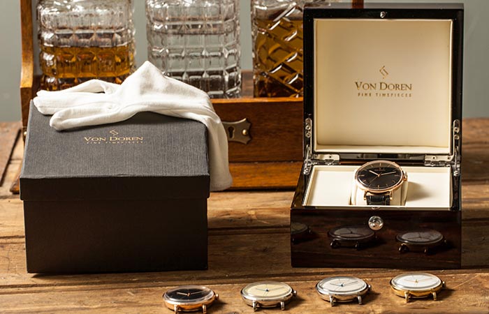 Von Doren watch faces on table and the box that it comes with