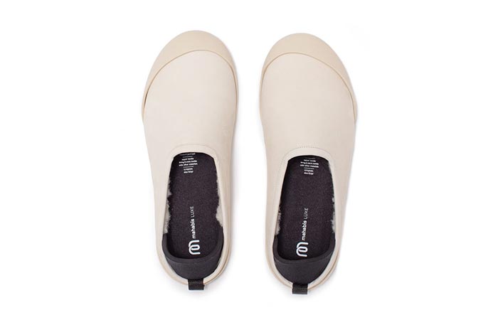 a pair of white mahabis luxe slippers