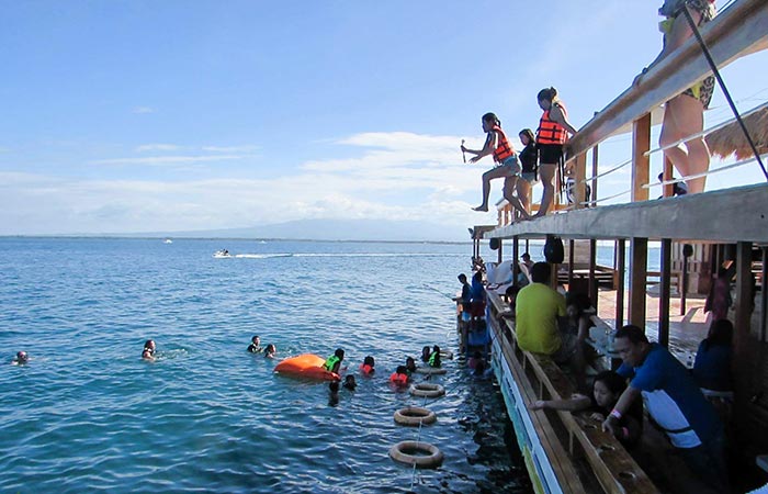 People jumping off the TawHai Floating Bar