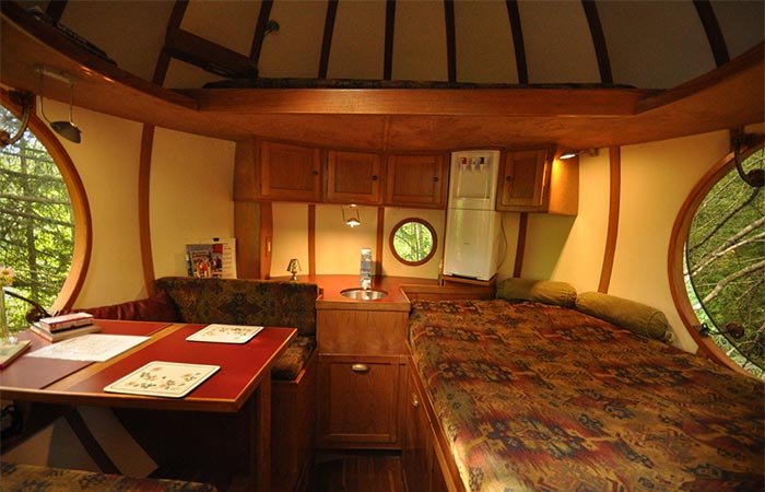 a bedroom and table inside Free Spirit Sphere