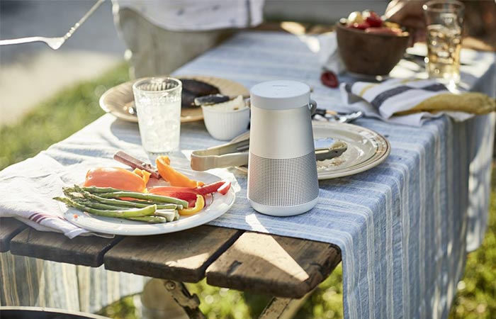 a white bluetooth speaker on a table