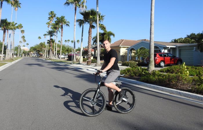 a guy riding a black Chainless bicycle