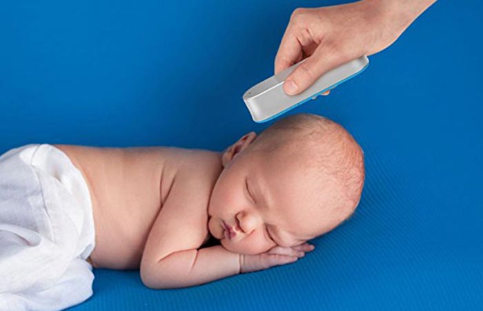 Baby's temperature being taken by the CliniCloud non-contact thermometer