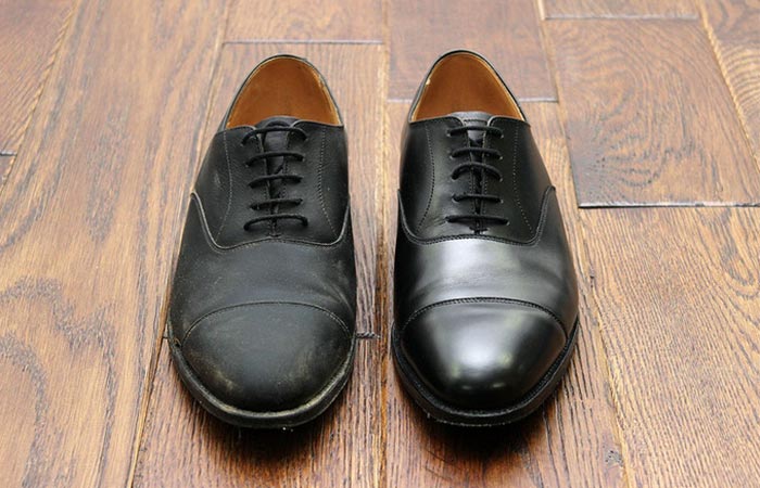one unpolished and one polished black leather shoe